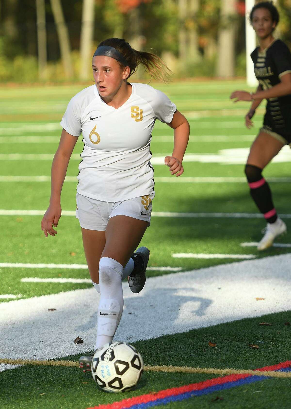 St. Joseph's Caroline Sheehan works the ball through midfield during their girls soccer match at rival Trumbull High School in Trumbull, Conn. on Thursday, October 15, 2020.