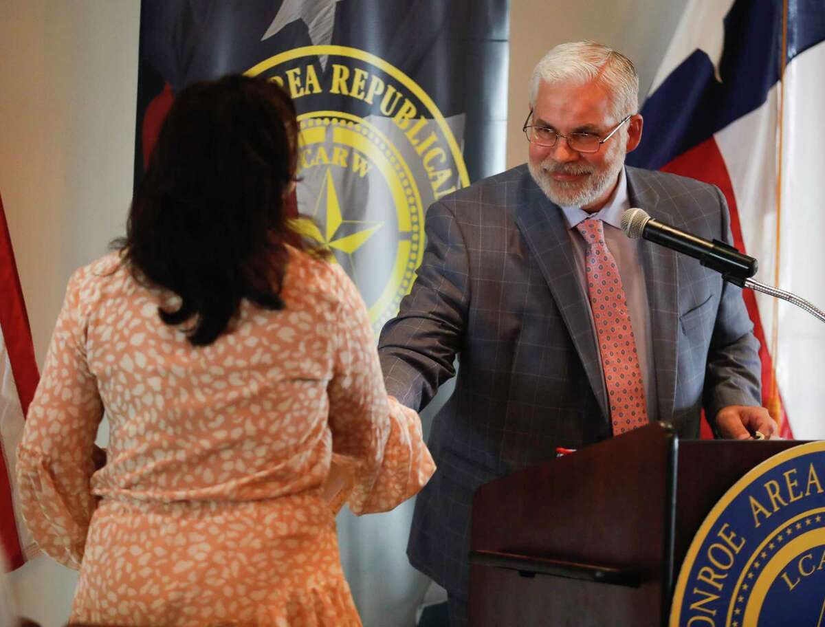 Kaufman Country District Attorney Erleigh Wiley, left, shakes hands with Montgomery County District Attorney Brett Ligon during a Lake Conroe Area Republican Women’s meeting, Thursday, Sept. 16, 2021, in Montgomery.