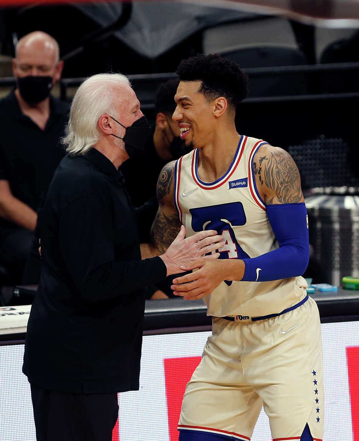 Head coach Gregg Popovich of the San Antonio Spurs greets Danny Green #14 of the Philadelphia 76ers in the first half at AT&T Center on May 2, 2021 in San Antonio, Texas. 
