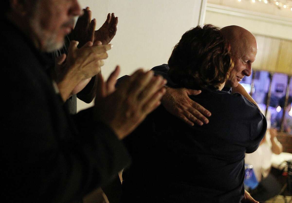Outgoing Harlandale ISD superintendent Robert Jaklich gets a hug from a supporter during a sendoff party in 2012. Jaklich had strong community support and his resignation under pressure from school board members caused turmoil and anger.
