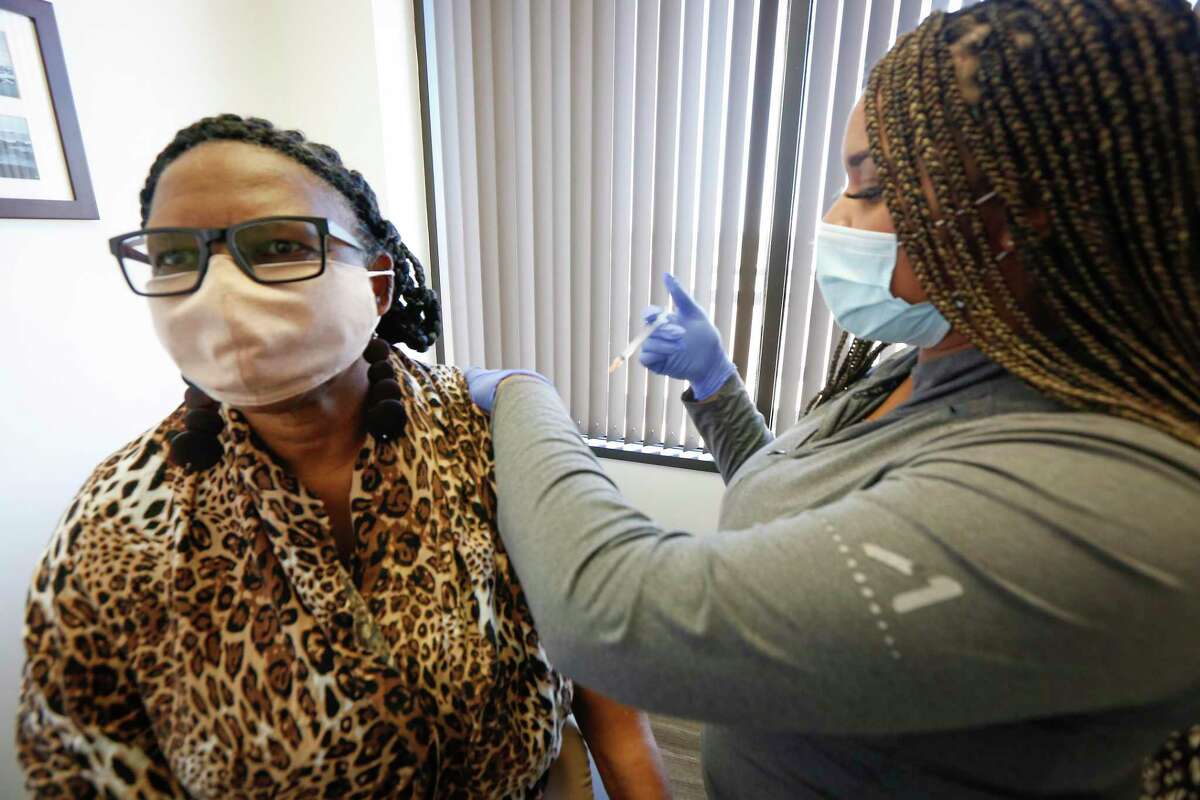 Xandra Williams-Earlie receives her flu shot by Candace Mabins in Dr. Gary Sheppard office Friday, Oct. 30, 2020, in Houston. Doctors are recommending flu shots earlier in 2022 amid indications the upcoming season could arrive earlier and be more severe.