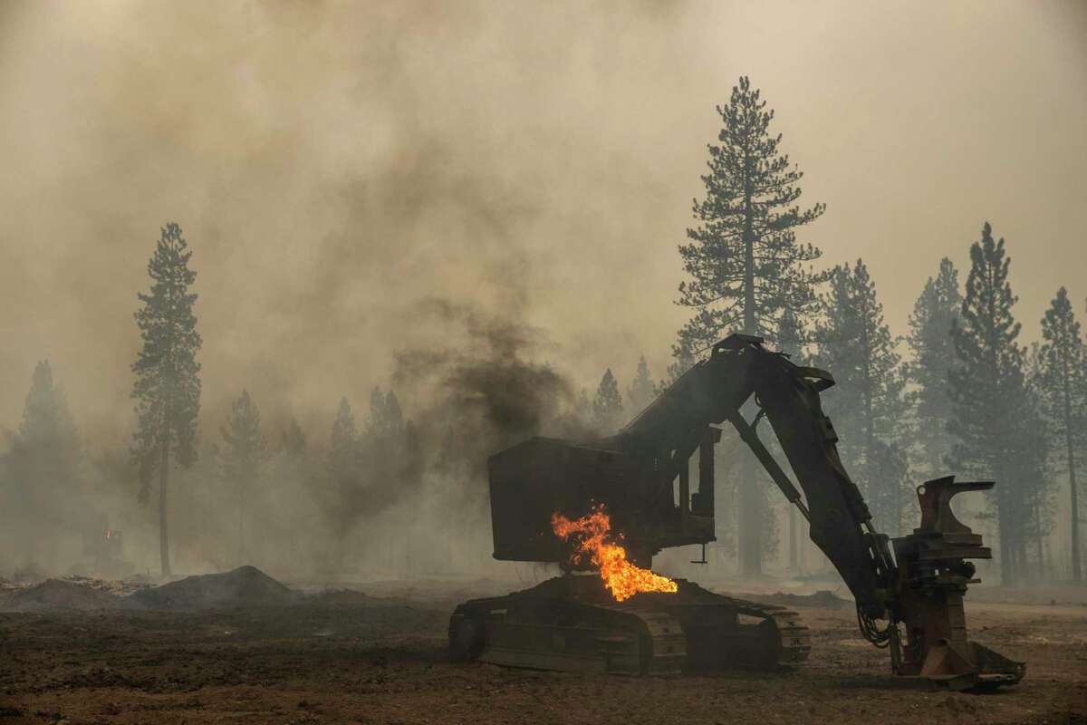 Burned-out heavy equipment along County Road 324 during the Dixie Fire in Chester (Plumas County) on Aug. 4.