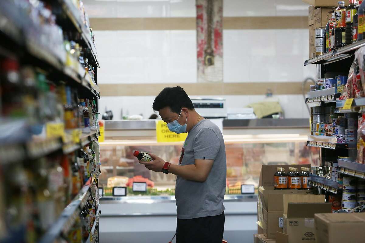 Are Bay Area mask mandates coming back? Here’s what to expect. A shopper selects items from a shelf while shopping at Suruki Supermarket on Thursday, August 12, 2021 in San Mateo,, Calif.
