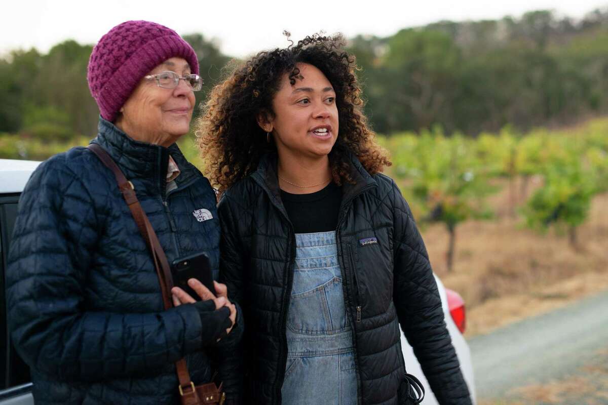 Chenoa Ashton-Lewis (right) takes a break from picking grapes to talk to her grandmother Justine Ashton.