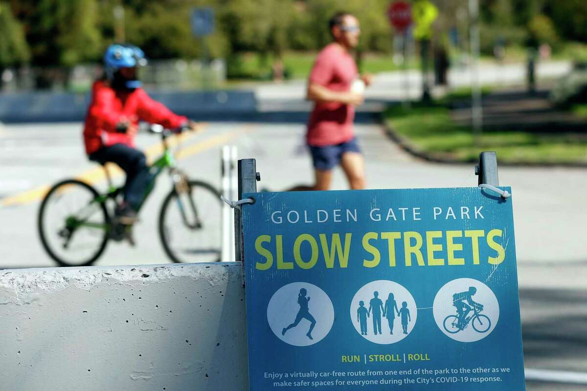 A Slow Streets sign is displaye dat John F. Kennedy Drive and Hagiwara Tea Garden Drive in San Francisco’s Golden Gate Park, in 2021.