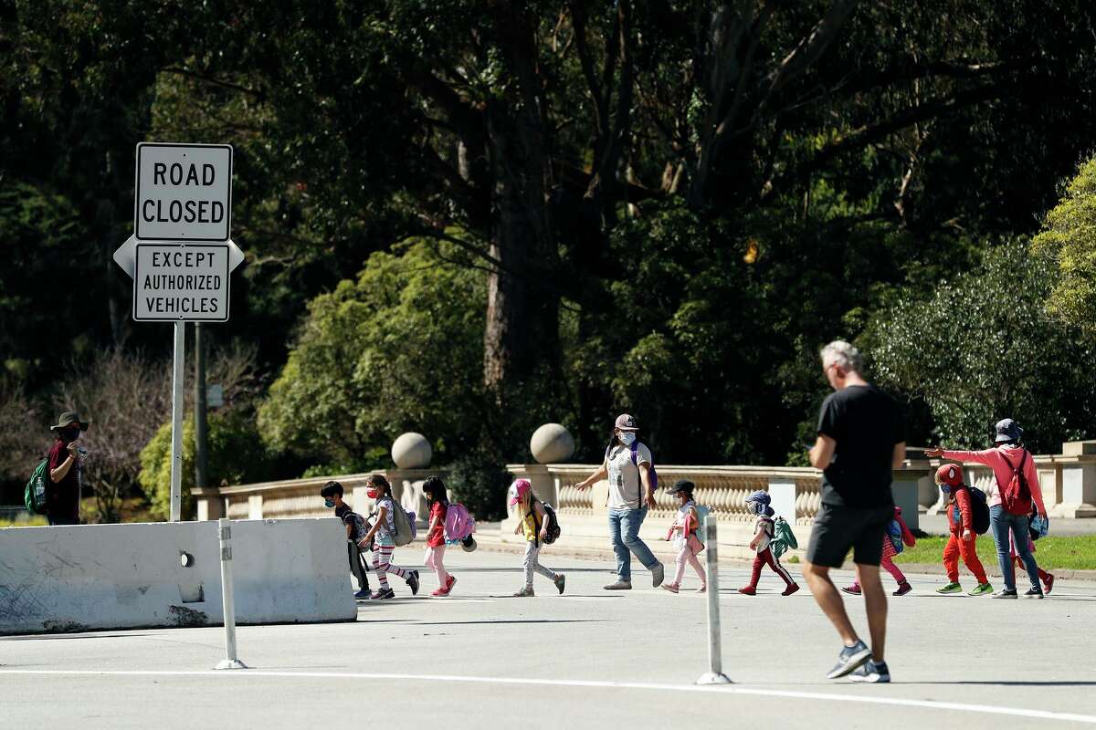 Children cross John F. Kennedy Drive at Hagiwara Tea Garden Drive on their way to the museums.