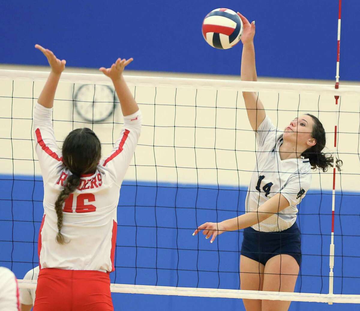 O’Connor’s Mackenzie Mahr (14) attempts to score against Taft’s Alondra Acevedo (16) in girls volleyball at Harlan Gym on Tuesday, Sept. 21, 2021. O’Connor swept Taft, 3-0 in sets, to earn the win. Mahr recorded a game high 14 kills.