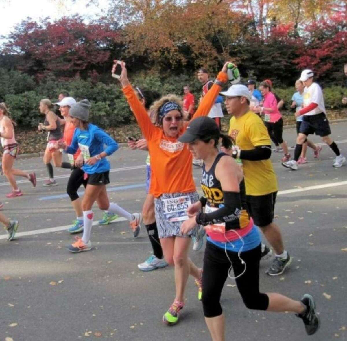 Ridgefield resident Claire Gladstone is preparing to run her 100th marathon in November. Pictured, Gladstone runs for Fred’s Team during the New York City Marathon in 2013.