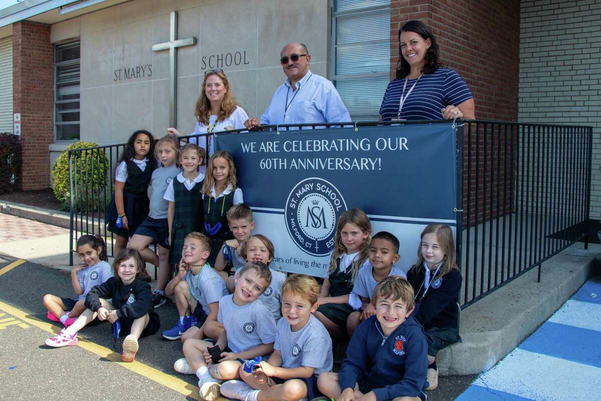 Saint Mary's School is celebrating its 60th anniversary. Pictured, along with Emily Nolan's first-grade class, is (from left) April Bryant, marketing/enrollment; Missy Dubin, assistant principal and Dominic Corraro, principal.