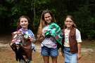 Girl Scout Troop 118037 members Emmie Likeness, 9, Amita Ramcharan, 10, and Rachel Rajabi, 8, pose with their vests to show off the Okay to Say mental health badge they earned late last year.