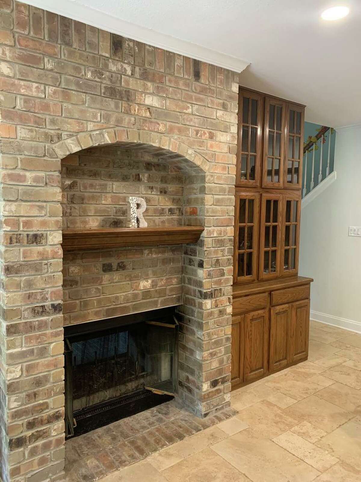 One of the kitchen features the couple wanted to keep is the brick-faced, double-sided wood-burning fireplace in the wall between the kitchen and the living room.