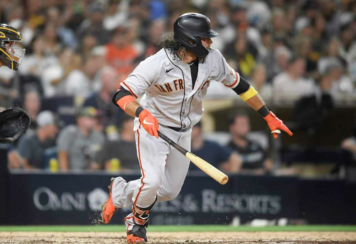 San Diego Padres catcher Victor Caratini throws to first for the out on San  Francisco Giants' LaMonte Wade Jr. during the second inning of a baseball  game Wednesday, Sept. 22, 2021, in