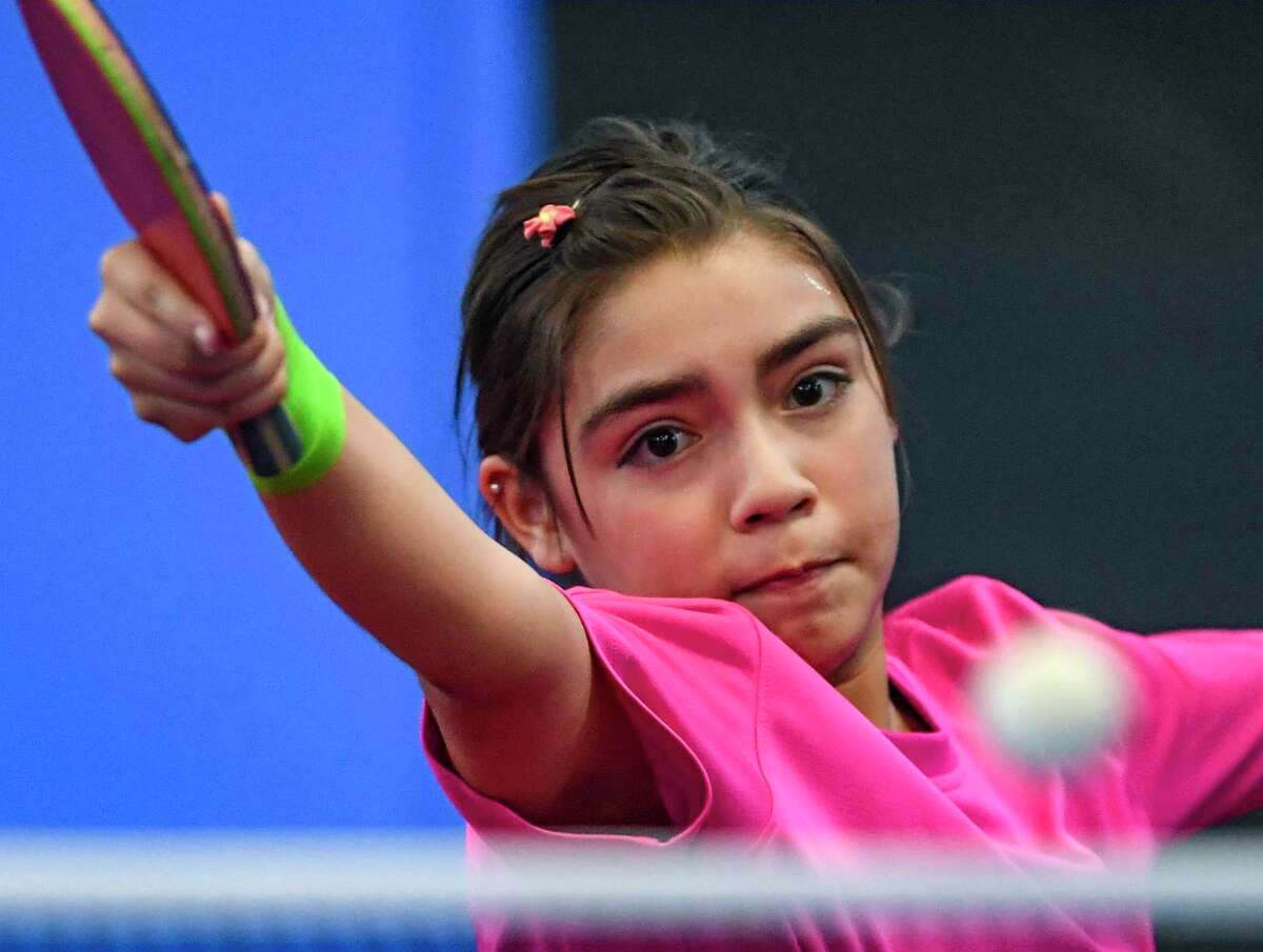 Eleven-year-old Lia Morales, a student at Harlandale Middle School, prepares to serve at the San Antonio Table Tennis Club on Monday, Sept. 20. She is a rising star in the world of table tennis, ranked No. 13 in the nation among 13 and under players.