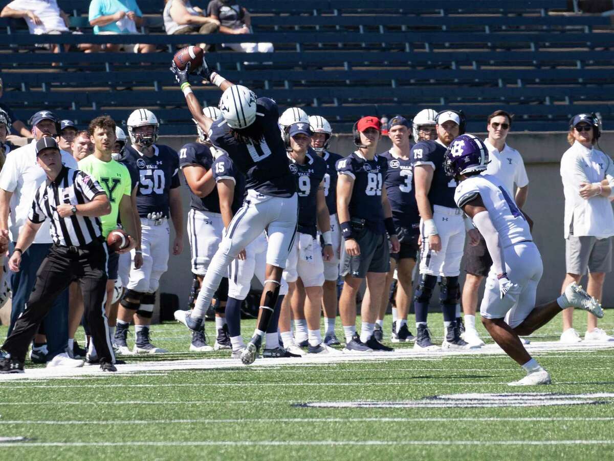 Yale wide receiver Darrion Harrington goes high to take in a sideline pass in Yale’s 20-14 loss to Holy Cross.