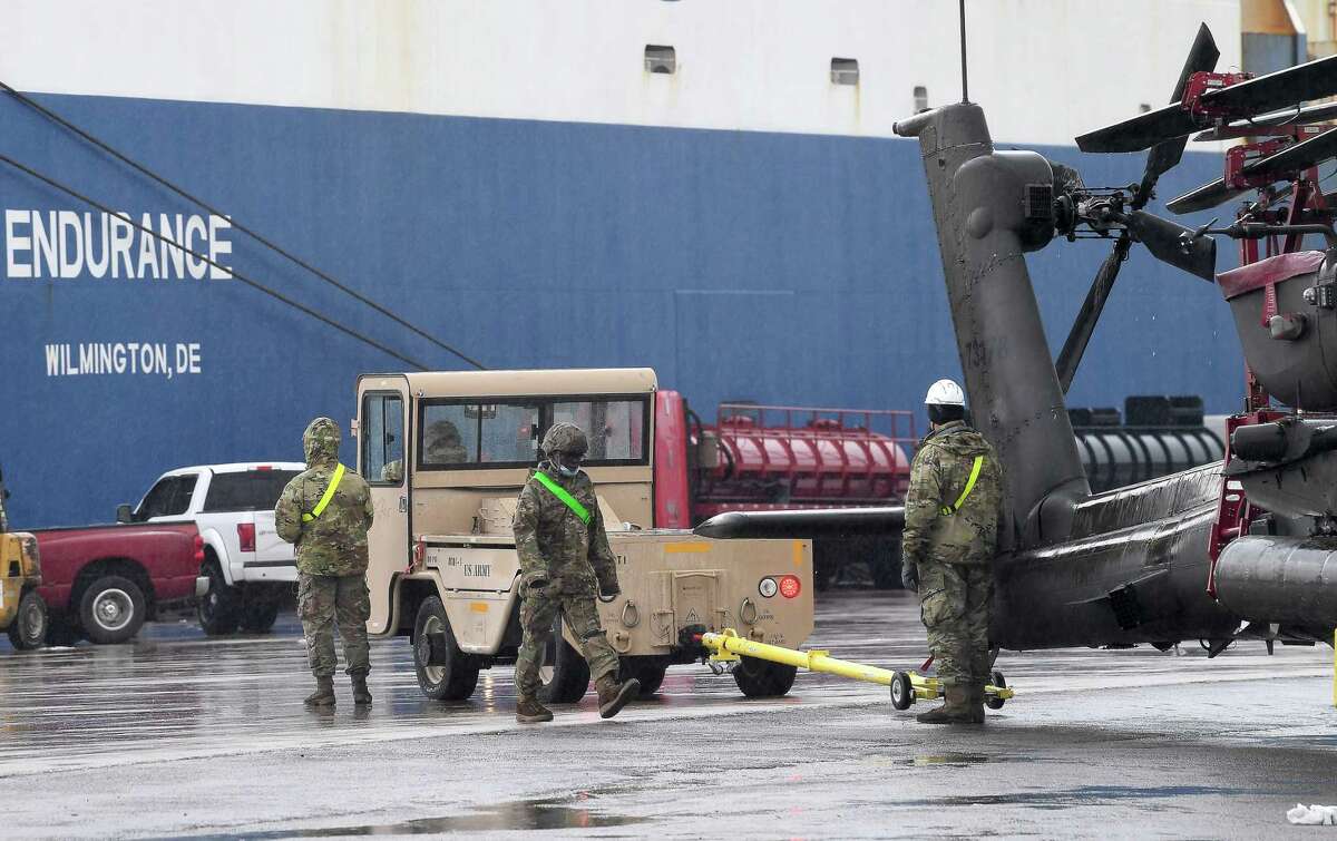 Members of the 842nd Transportation Battalion load helicopters and other military vehicles onto a vessel docked at the Port of Beaumont. The cargo is bound for Europe to be used in military training with NATO allies. A second vessel arrives Monday to transport the remaining cargo from the port. Photo taken Thursday, February 4, 2021 Kim Brent/The Enterprise