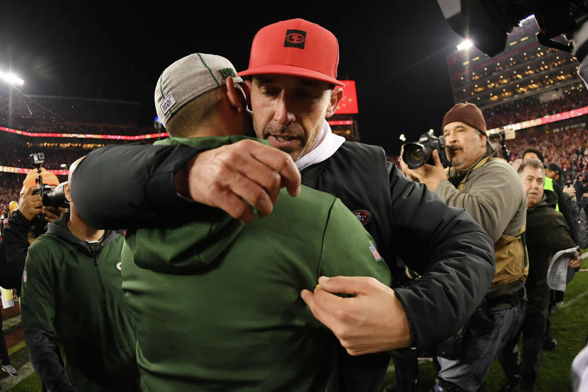 Head coach Kyle Shanahan of the San Francisco 49ers hugs head coach Matt LaFleur of the Green Bay Packers