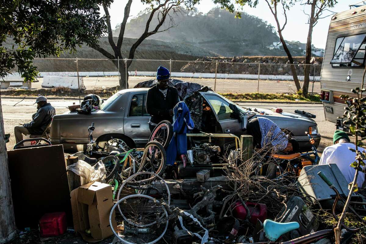 James Keys, 59, organizes belongings outside by his car parked along Hunters Point Expressway in San Francisco.