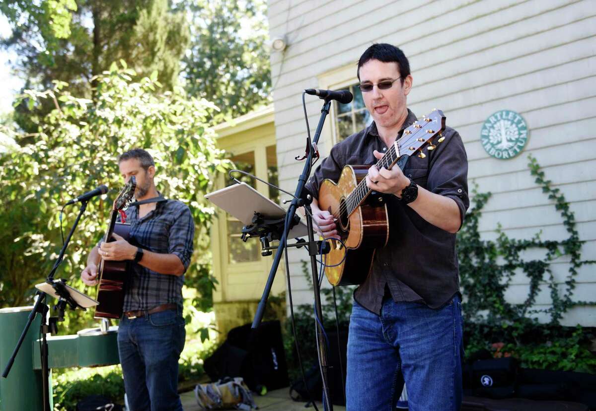 Kris Bauman, left, and Peadar Hickey performs at the Honey Harvest Festival at Bartlett Arboretum in Stamford, Conn. Sunday, Sept. 19, 2021. The free festival featured an artisan marketplace with more than 20 local vendors, live music, a free yoga and Zumba class, honey and mead tastings, food trucks, children's crafts, and a beekeeping panel discussion.
