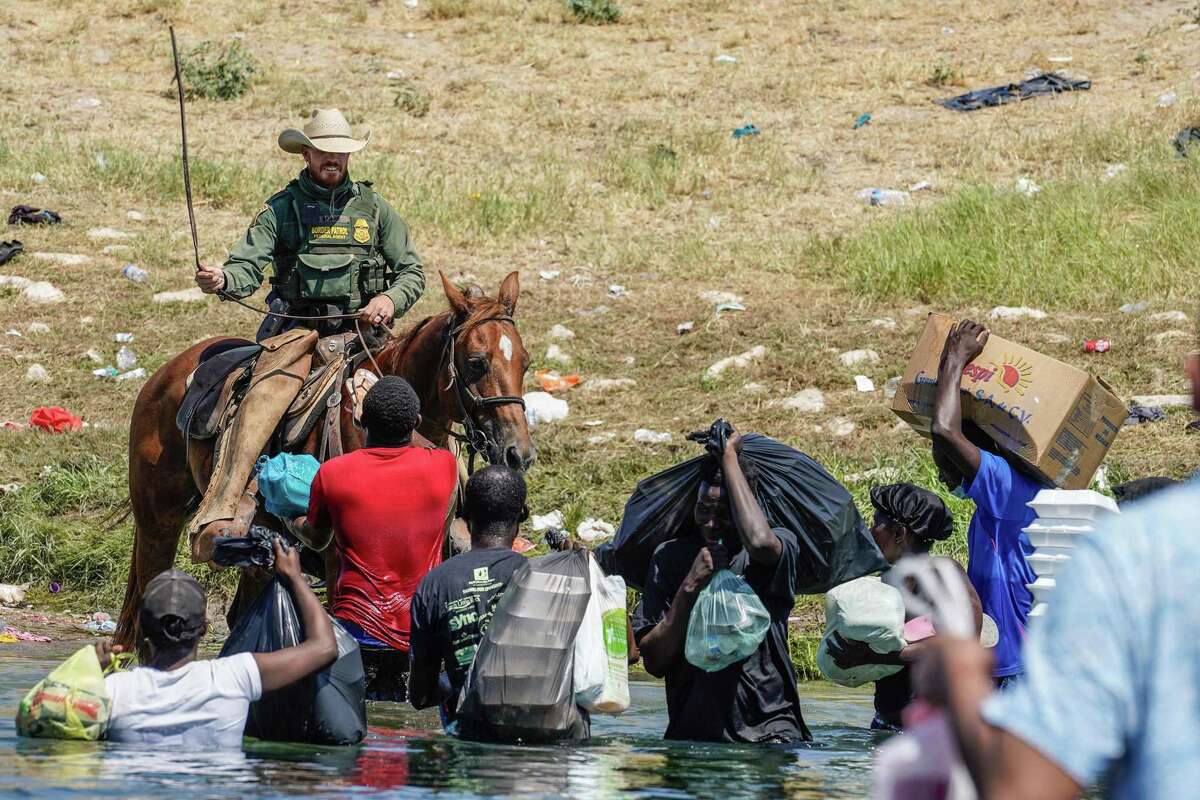 A U.S. Border Patrol agent on horseback raises his reins as he tries to stop Haitian migrants from entering an encampment on the banks of the Rio Grande near the Acuña Del Rio International Bridge in Del Rio on Sept. 19.