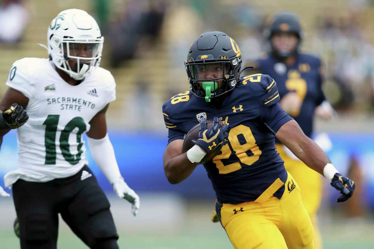 California running back Damien Moore (28) runs against Sacramento State safety Malik Jeter (10) during the second half of an NCAA college football game on Saturday, Sept. 18, 2021, in Berkeley, Calif. (AP Photo/Jed Jacobsohn)