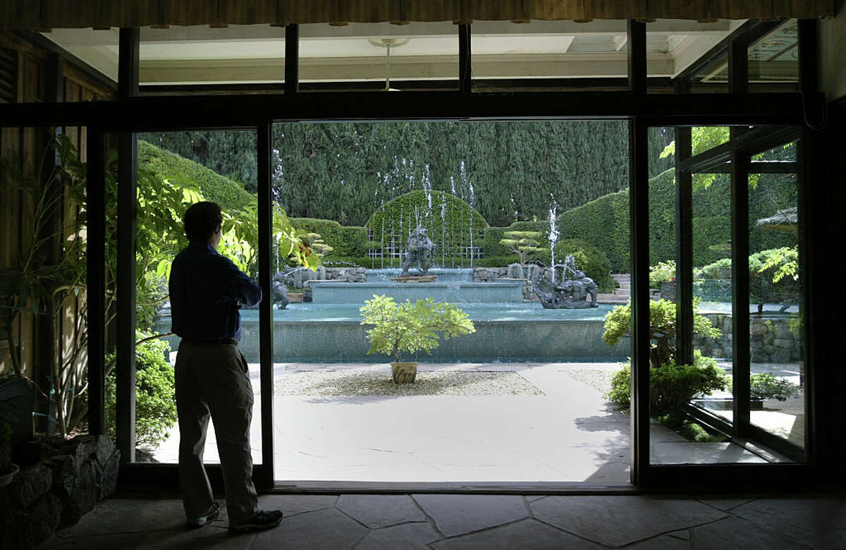 The living room at Fred Joerger's Lakeview Terrace home, pictured Sept. 14, 2005, provides a backyard view of the infinity pool built in the 1970s. He designed his own home and garden in 1952 with lots of falls, fountains, pools, ponds and rocks. The current owner has kept it true to its kitsch roots.