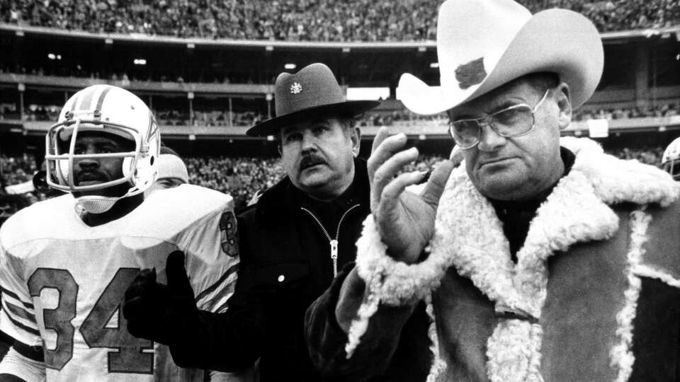 Houston Oilers coach Bum Phillips and running back Earl Campbell leave the field after a second consecutive loss to Pittsburgh in the AFC title game.