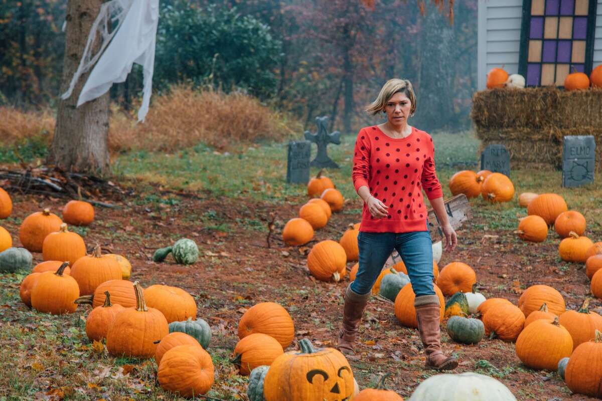 Photo of Coatesville students posing with pumpkins carved with