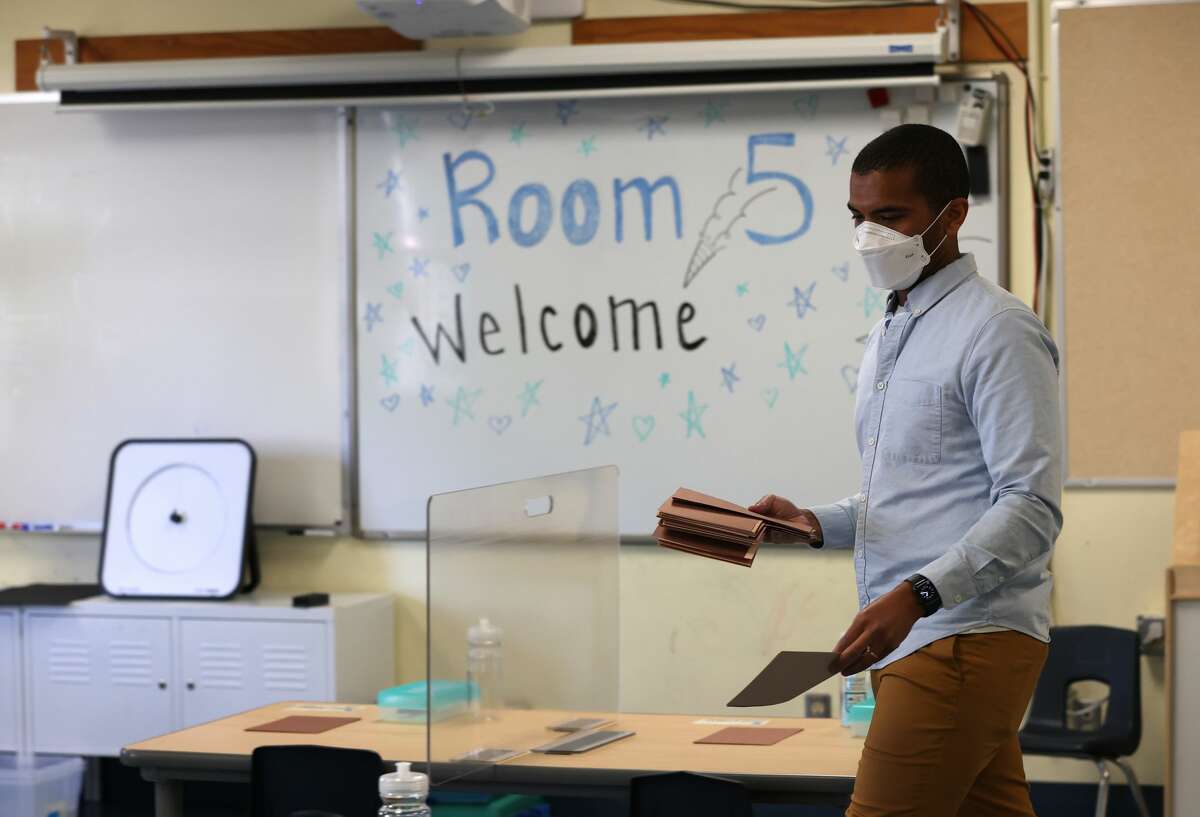 Bryant Elementary School kindergarten teacher Chris Johnson sets up his classroom on April 9, 2021, in San Francisco. 