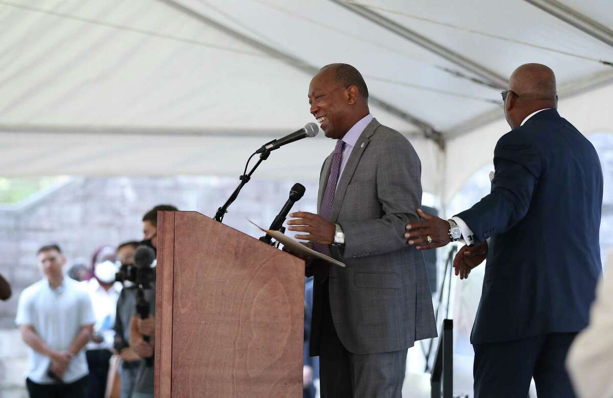 Mayor Sylvester Turner laughs with Fifth Ward CRC, founder and board chair emeritus Reverend Harvey Clemons during a groundbreaking at the old St. Elizabeth Hospital in the Fifth Ward, which is being converted into mixed-income housing, Friday, September 24, 2021, in Houston. The project has attracted some controversy among neighbors, some of whom have decried it as gentrification.