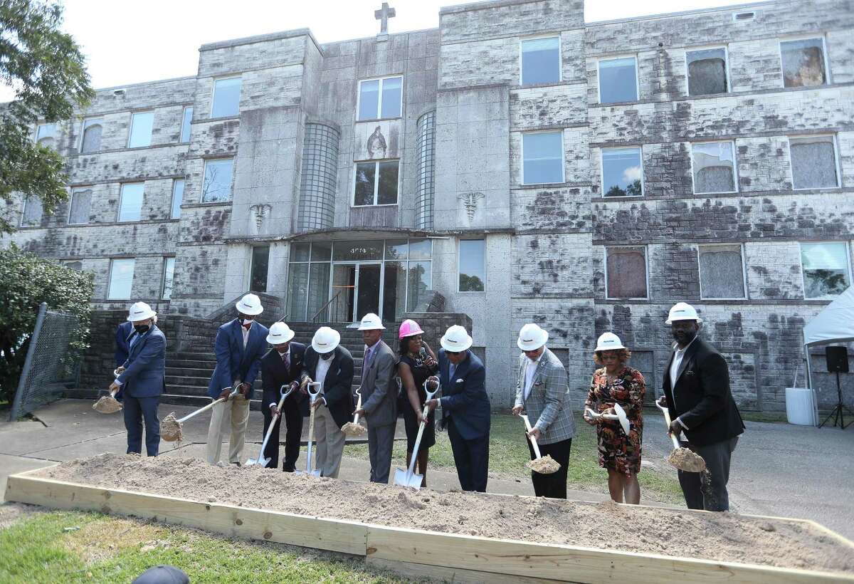 Mayor Sylvester Turner along with Fifth Ward CRC President and CEO, Kathy Flanagan Payton (pink hardhat) and founder and board chair emeritus Reverend Harvey Clemons and others broke ground at the old St. Elizabeth Hospital in the Fifth Ward, which is being converted into mixed-income housing, Friday, September 24, 2021, in Houston. The project has attracted some controversy among neighbors, some of whom have decried it as gentrification.