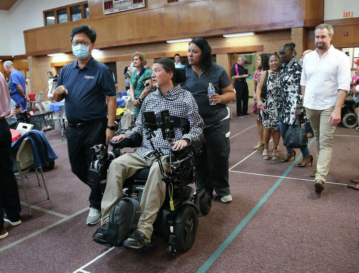 Dr. Rex Marco, talks to friends and family at his "Dr. Marco's Alive Day" in Houston on Wednesday, July 21, 2021. Dr. Marco, a spine surgeon and musculoskeletal oncologist, was paralyzed in a mountain bike accident in 2019.