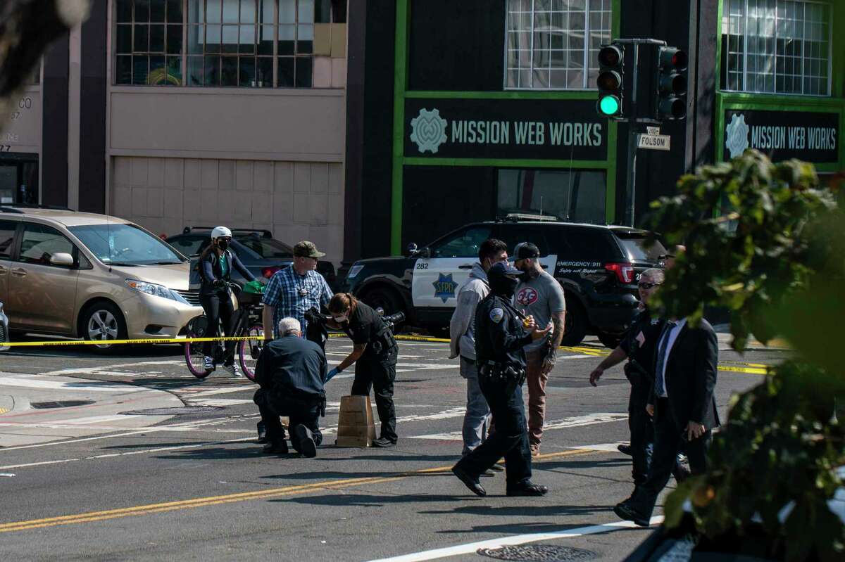 Members of the San Francisco Police Department gather evidence at the scene of a homicide on Folsom Street between 16th and 17th Street in San Francisco, Calif. Friday, Sept. 24, 2021.