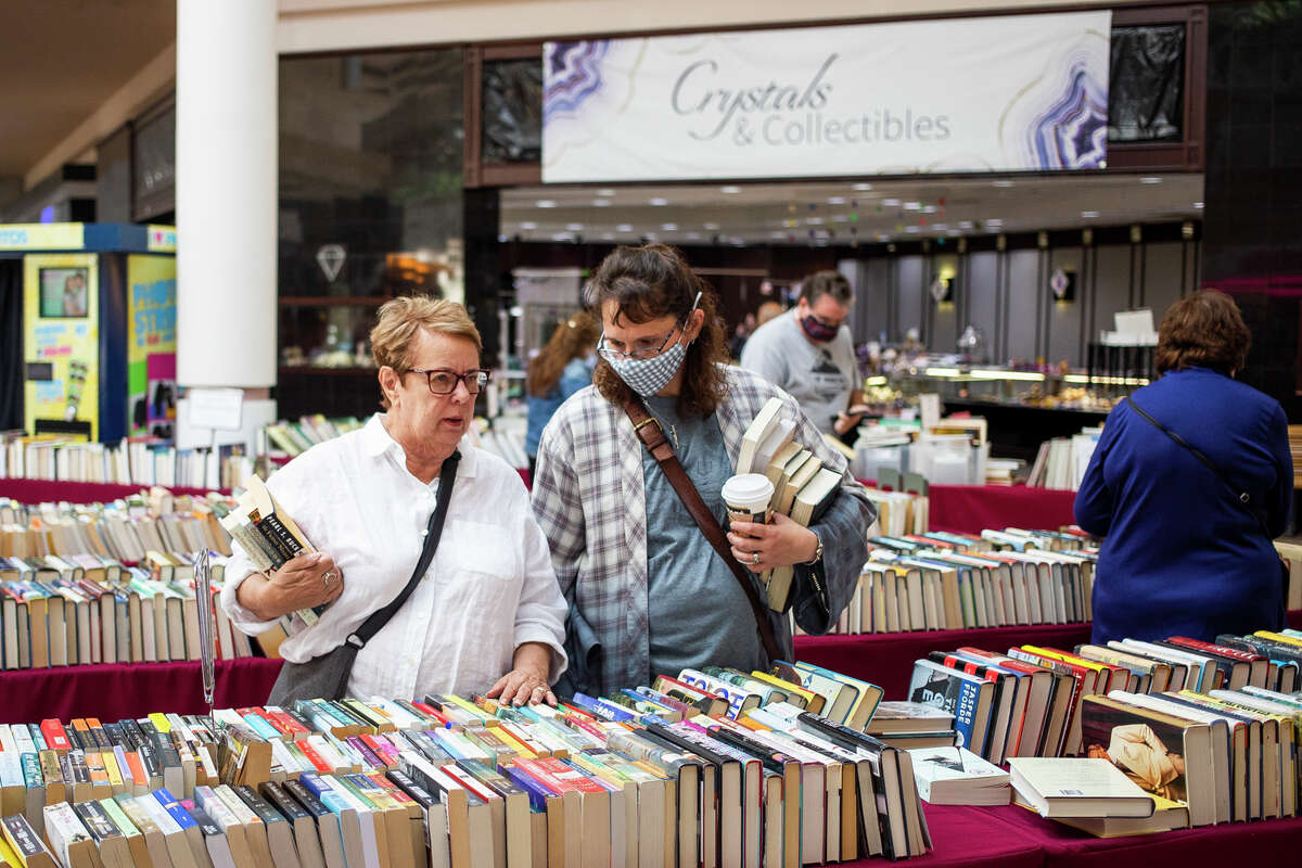 Shoppers peruse hundreds of used books during the American Association of University Womenâs (AAUW) Fall Used Book Sale Friday, Sept. 24, 2021 at the Midland Mall. (Katy Kildee/kkildee@mdn.net)