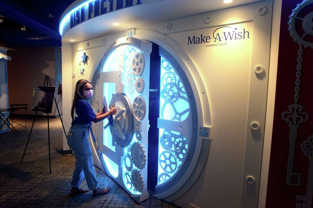 Volunteer Jillian Duffy opens the door of the “Wish Factory” last week at Make-A-Wish Connecticut’s new headquarters in Trumbull.