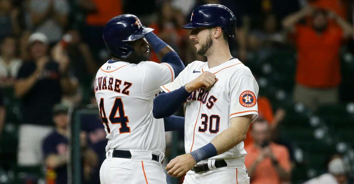 Houston Astros right fielder Kyle Tucker (30) celebrates with designated hitter Yordan Alvarez (44) after hitting a two-RBI home run against Cleveland during the fifth inning of an MLB game at Minute Maid Park on Tuesday, July 20, 2021, in Houston.