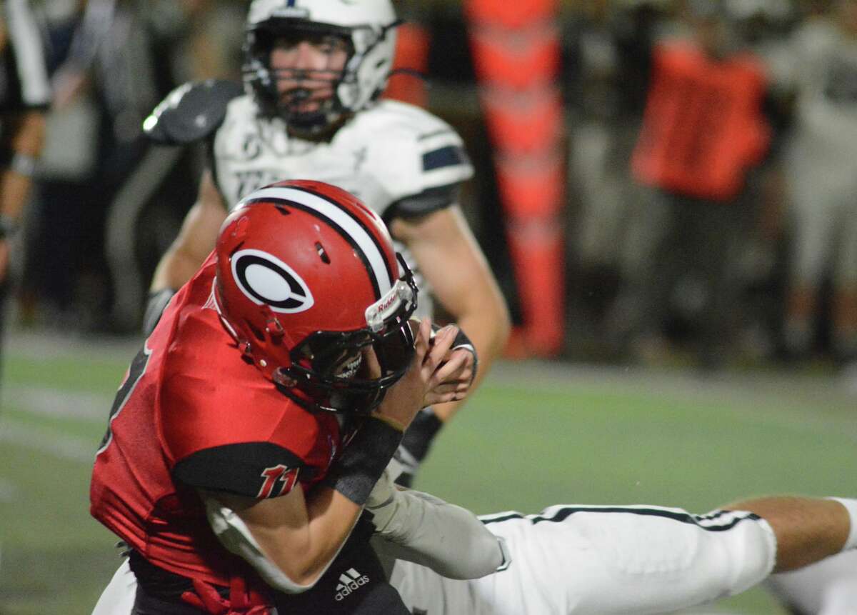 Cheshire’s Mike Simeone carries the ball for a gain against Staples on Friday.