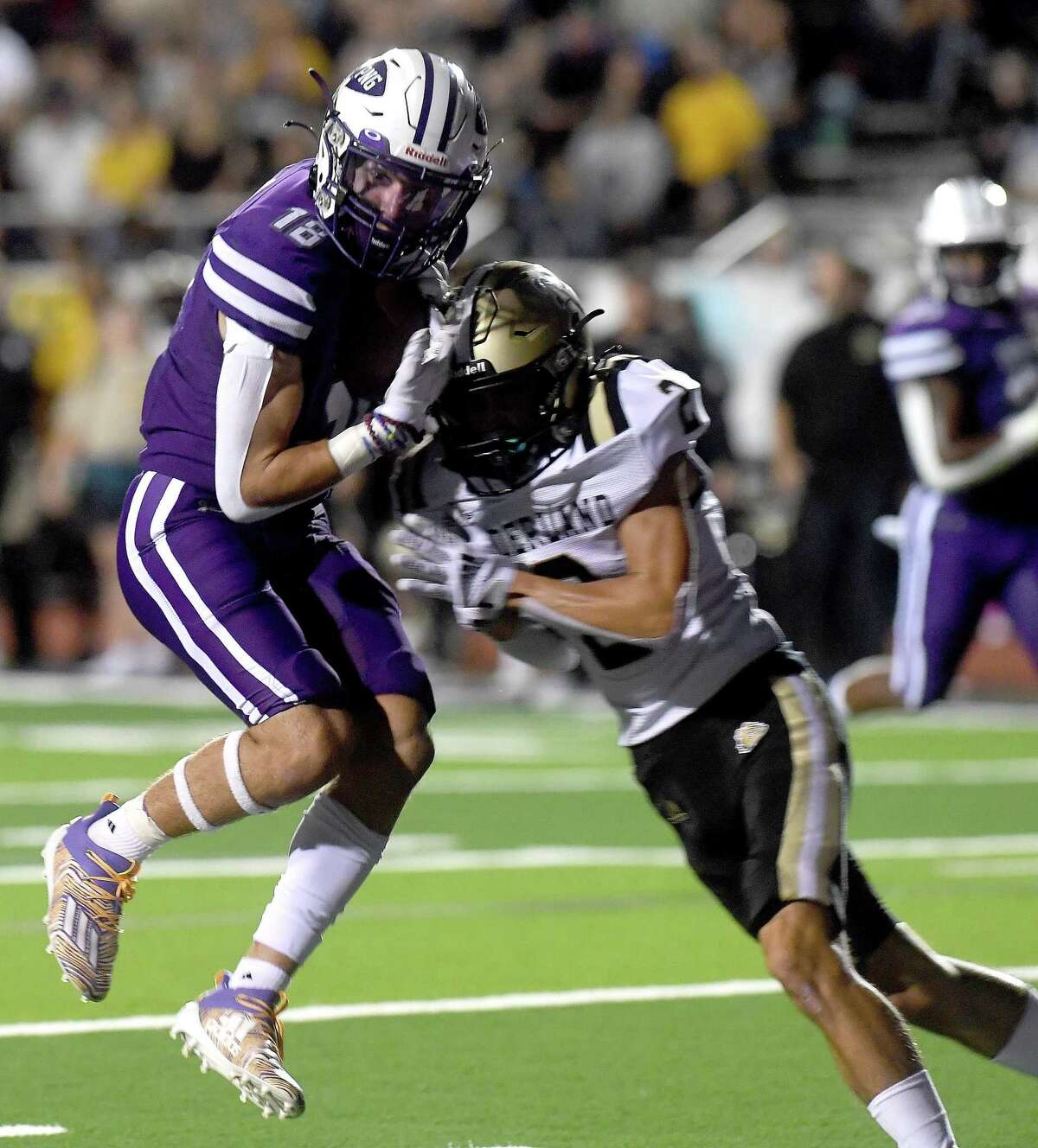 Port Neches-Groves' Chance Prosperie leaps into the end zone as Nederland's Slade Stoker closes in during Friday's Mid-County match-up at PNG. Photo made Friday, September 24, 2021 Kim Brent/The Enterprise
