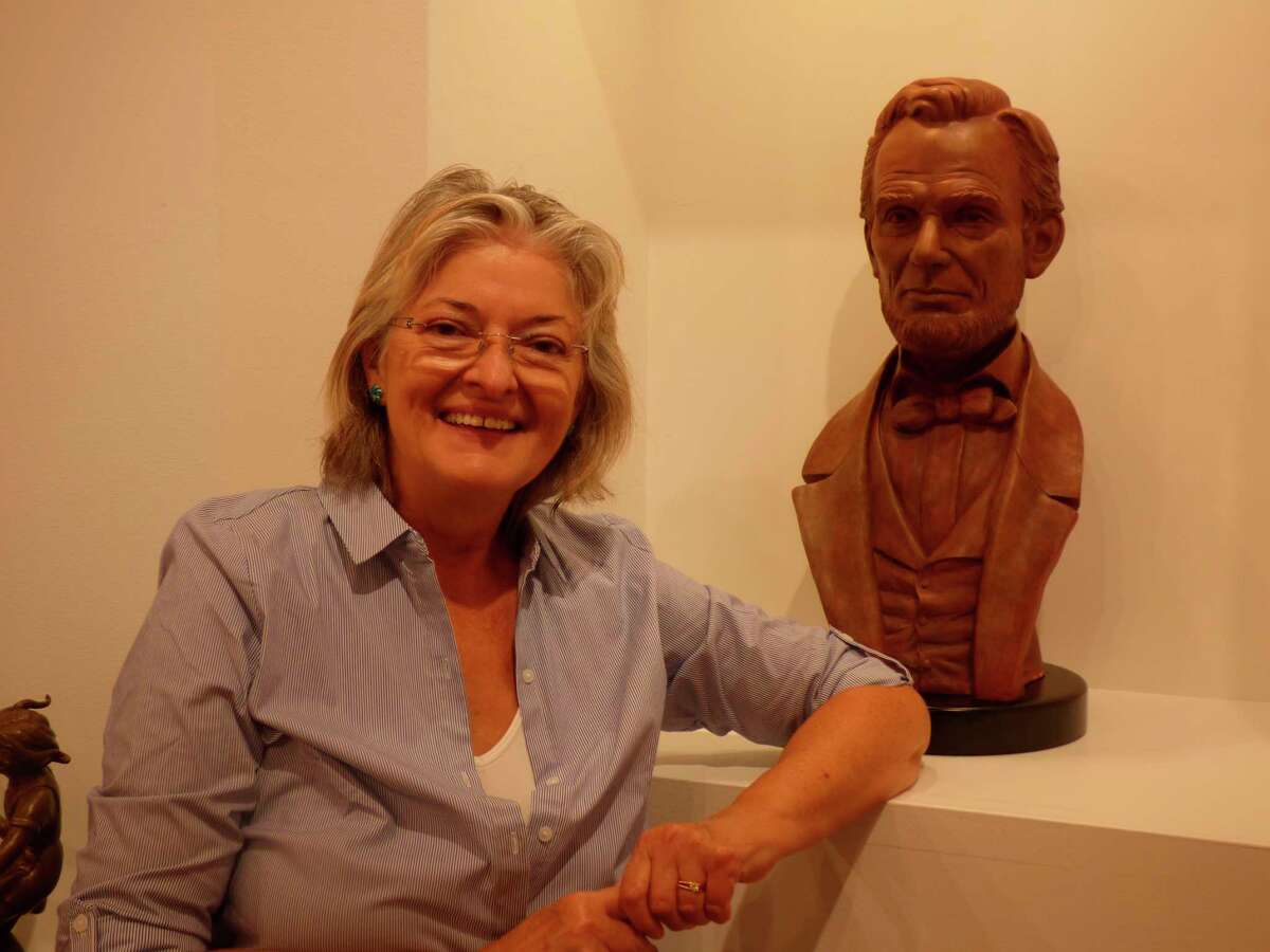 Artist Bernadette Zachara-Marcos poses with a bust she made of Abraham Lincoln. An exhibit of her work is currently on display at the Ramsdell Regional Center for the Arts. Zachara-Marcos has been commissioned to create a statue of actor James Earl Jones and his mentor Donald Crouch by the Arts and Cultural Alliance of Manistee County. (Scott Fraley/News Advocate)
