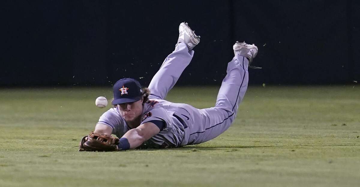 Houston Astros center fielder Jake Meyers cannot catch an RBI-single hit by Oakland Athletics' Starling Marte during the eighth inning of a baseball game in Oakland, Calif., Friday, Sept. 24, 2021. (AP Photo/Jeff Chiu)