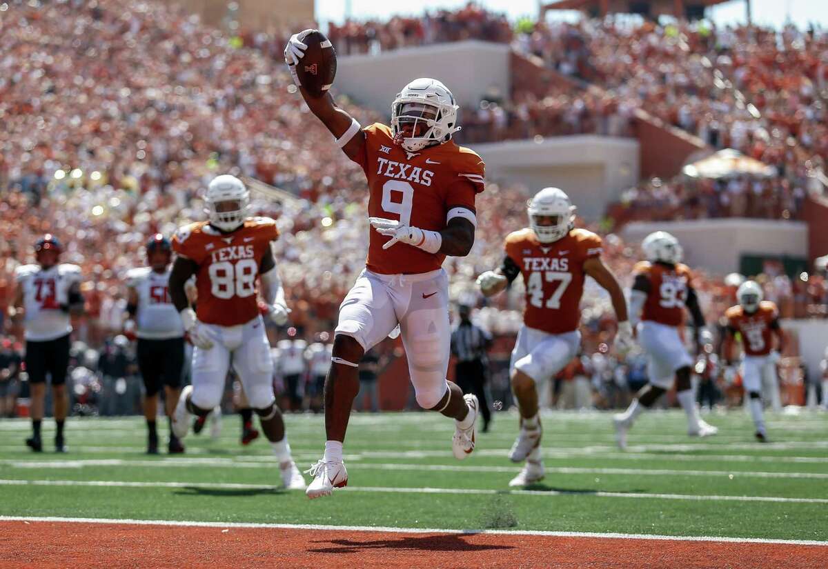 AUSTIN, TEXAS - SEPTEMBER 25: Josh Thompson #9 of the Texas Longhorns intercepts a pass and returns it for a touchdown in the second quarter against the Texas Tech Red Raiders at Darrell K Royal-Texas Memorial Stadium on September 25, 2021 in Austin, Texas.