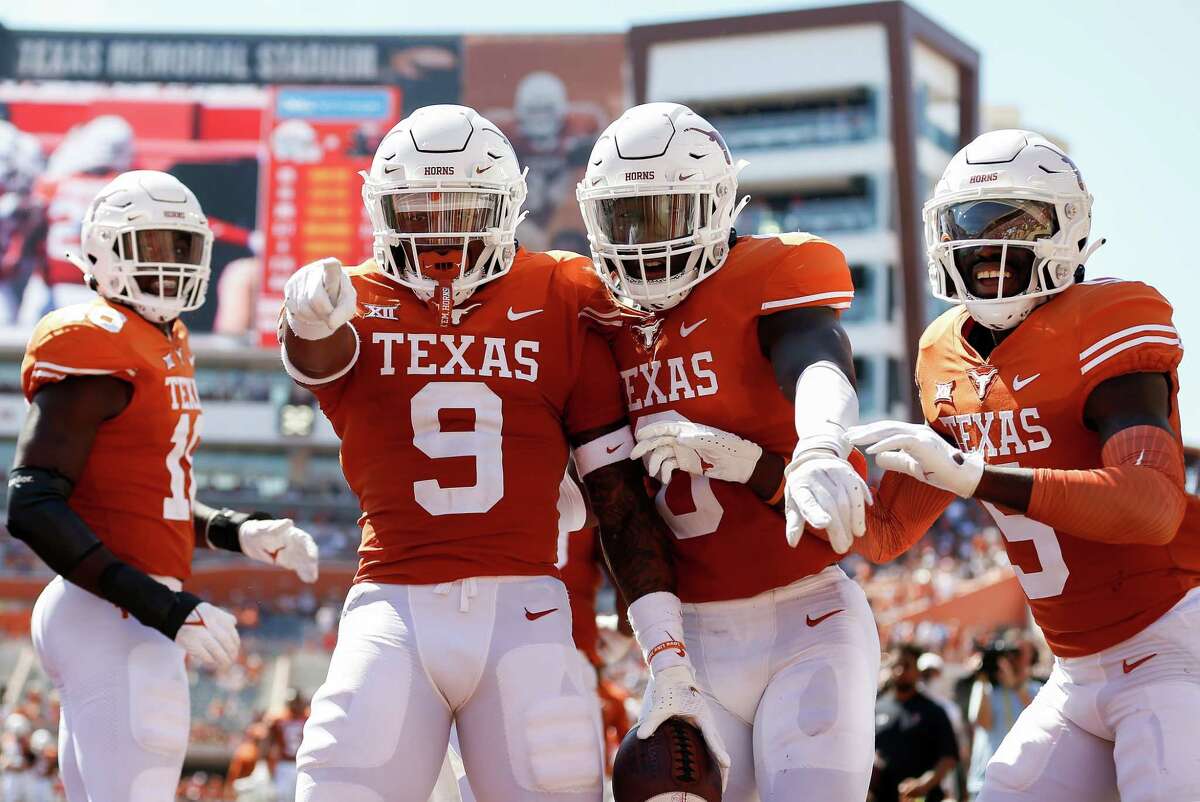 AUSTIN, TEXAS - SEPTEMBER 25: Josh Thompson #9 of the Texas Longhorns celebrates with teammates after an interception return for a touchdown in the second quarter against the Texas Tech Red Raiders at Darrell K Royal-Texas Memorial Stadium on September 25, 2021 in Austin, Texas.
