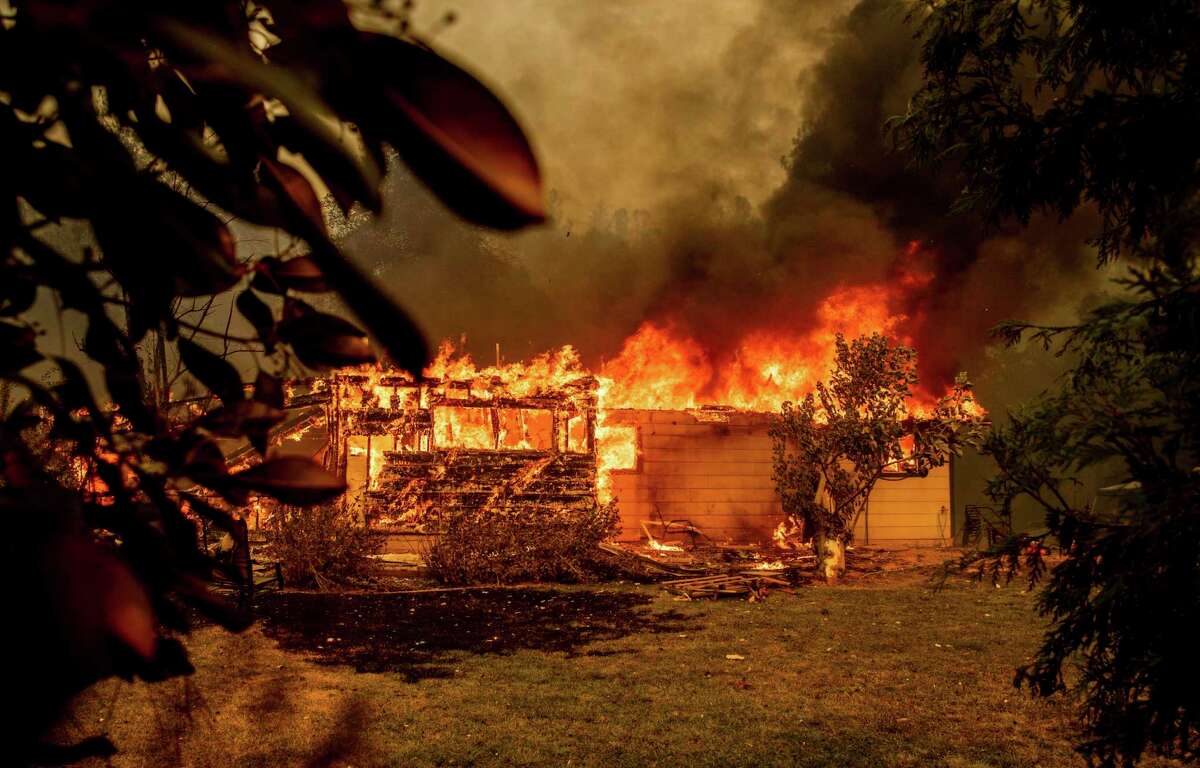 A house near Old Oregon Trail goes up in flames as the Fawn Fire burns north of Redding in Shasta County on Thursday. The blaze was still spreading on Saturday.