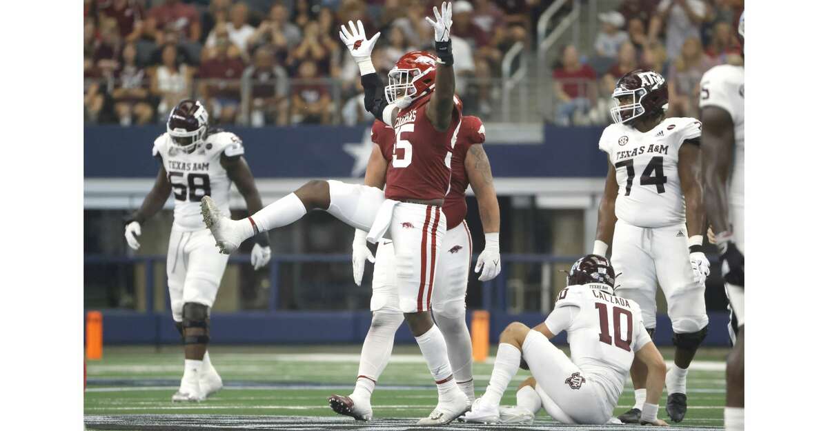 Tre Williams #55 of the Arkansas Razorbacks reacts after taking down Zach Calzada #10 of the Texas A&M Aggies in the first half of the Southwest Classic at AT&T Stadium on September 25, 2021 in Arlington, Texas. Arkansas won 20-10. (Photo by Ron Jenkins/Getty Images)