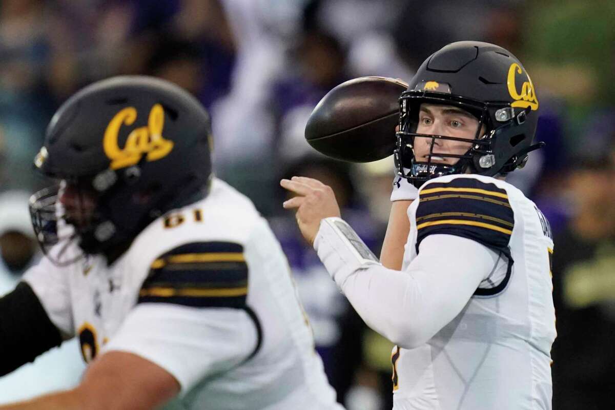 California quarterback Chase Garbers, right, passes against Washington during the first half of an NCAA college football game, Saturday, Sept. 25, 2021, in Seattle. (AP Photo/Elaine Thompson)