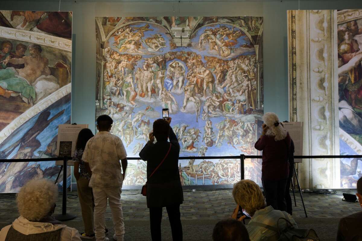 Visitors see a new art installation recreating the Sistine Chapel for an exhibition at St. Mary's Cathedral in San Francisco on September 24, 2021.