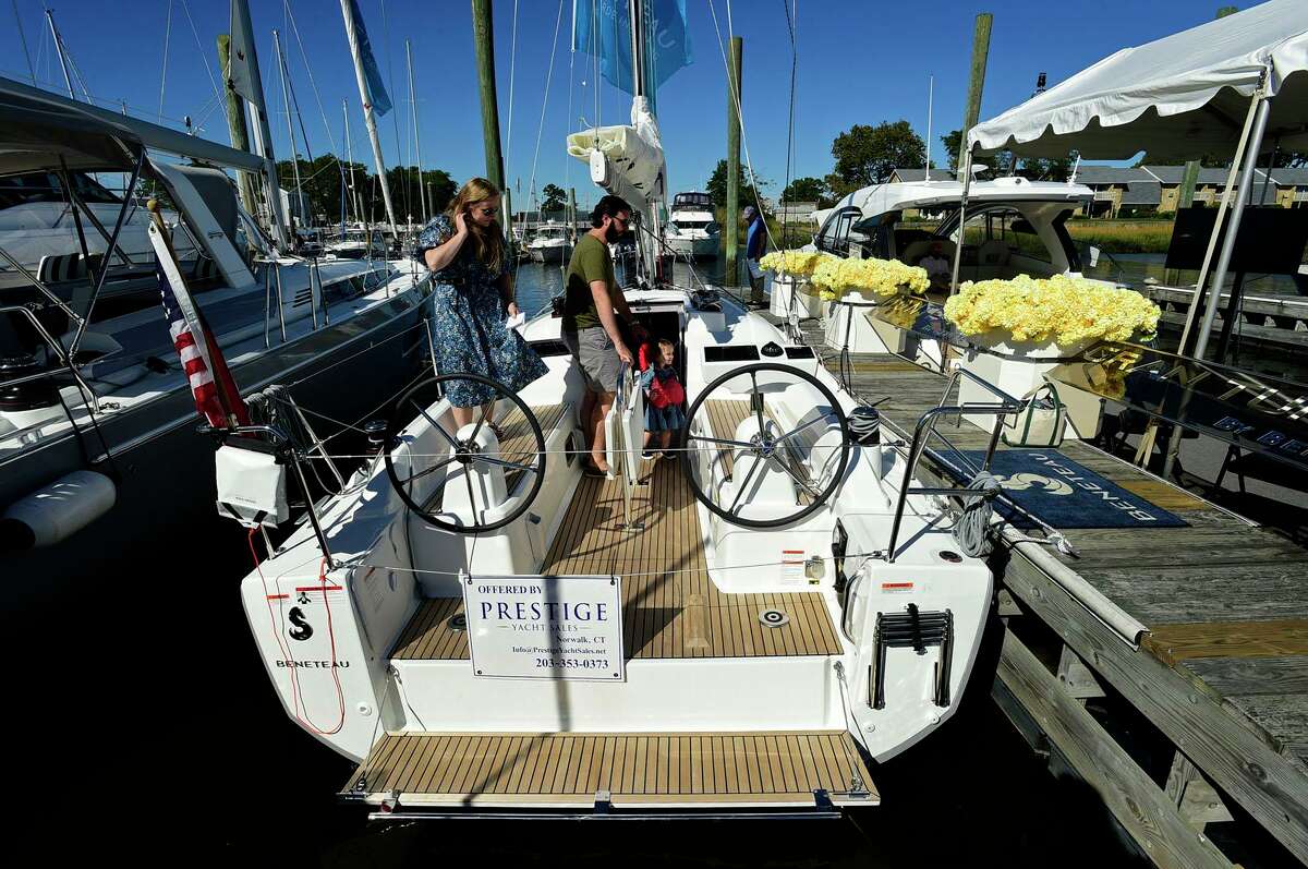 Visitors including Lou Cona, his daughter Isabella Cona, 1, and his wife Laura Cona of Darien browse the watercraft at the Norwalk Boat Show Saturday, Sept. 25, 2021 at Cove Marina in Norwalk, Connecticut.