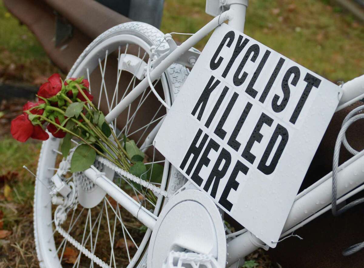 A white-painted “ghost bike” memorial in Bethel in 2013, at the scene where 59-year-old Weston resident Thomas Steinert-Threlkeld was killed in a hit-and-run accident. Some say motor vehicle-bicycle accidents have reached a criris and advocates are using that as an argument for a climate initiative.