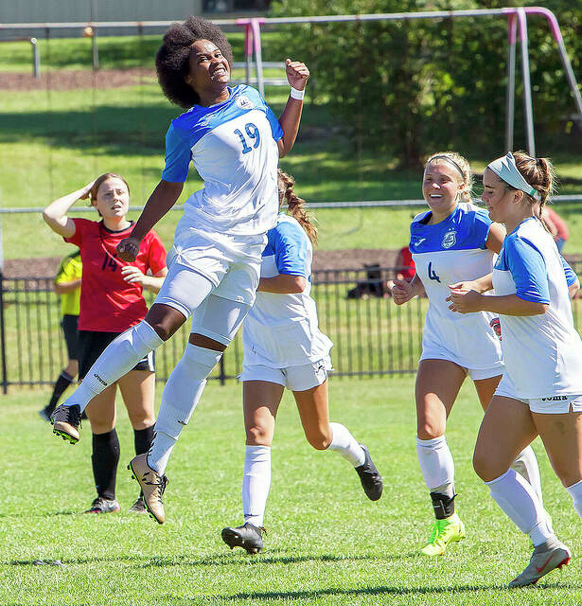 Freshman Chrissy Mitchell (19) leaps into the air to celebrate one of her two goals against Wabash Valley in Saturday’s 2-0 Region 24 victory at Tim Rooney Stadium.