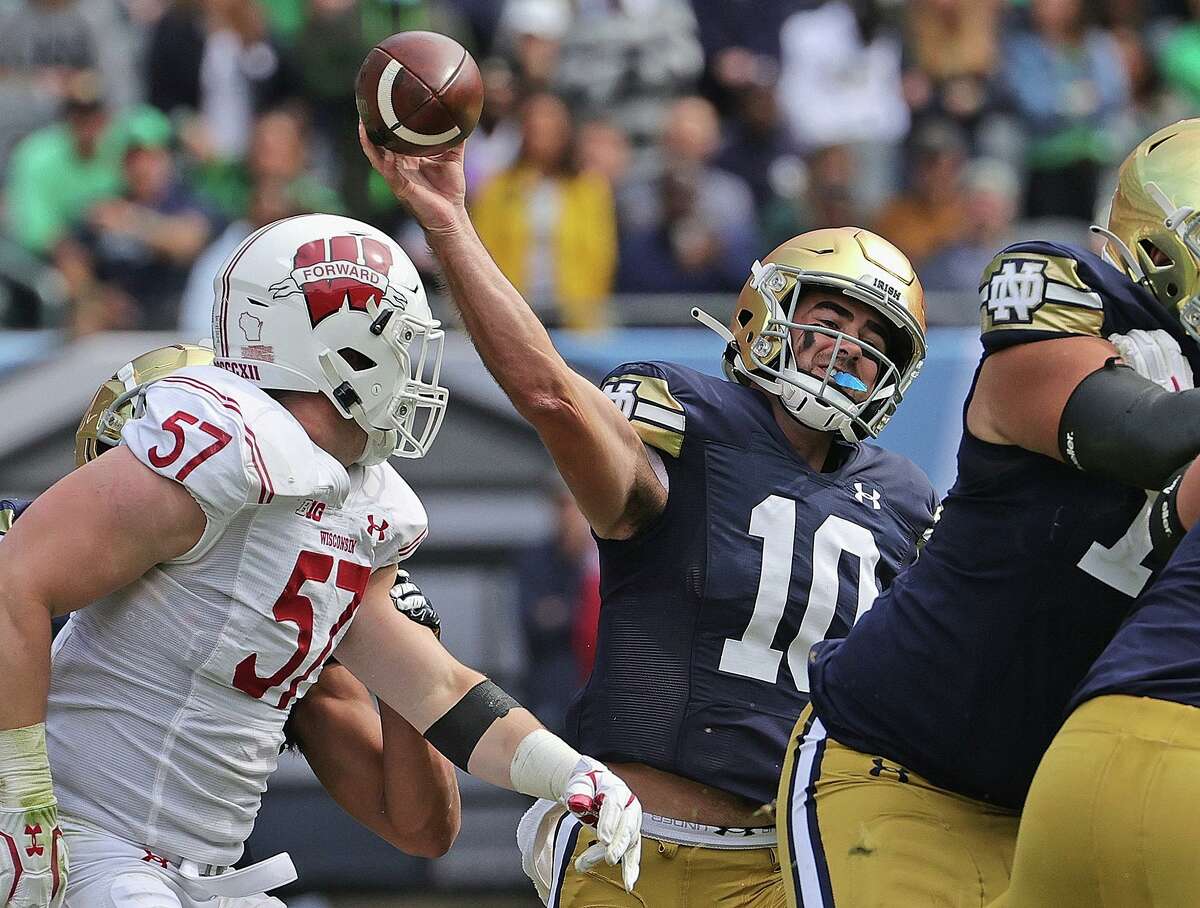 Drew Pyne (10) of the Notre Dame Fighting Irish passes over Jack Sanborn (57) of the Wisconsin Badgers at Soldier Field on September 25, 2021 in Chicago, Illinois. Notre Dame defeated Wisconsin 41-13. (Jonathan Daniel/Getty Images/TNS)