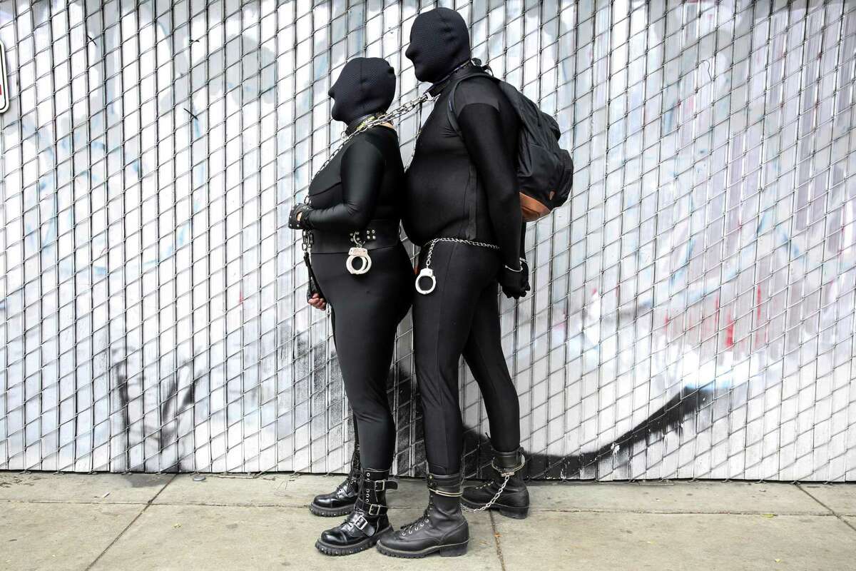 A couple who seem to have no problem at all with wearing face coverings attend the Folsom Street Fair.